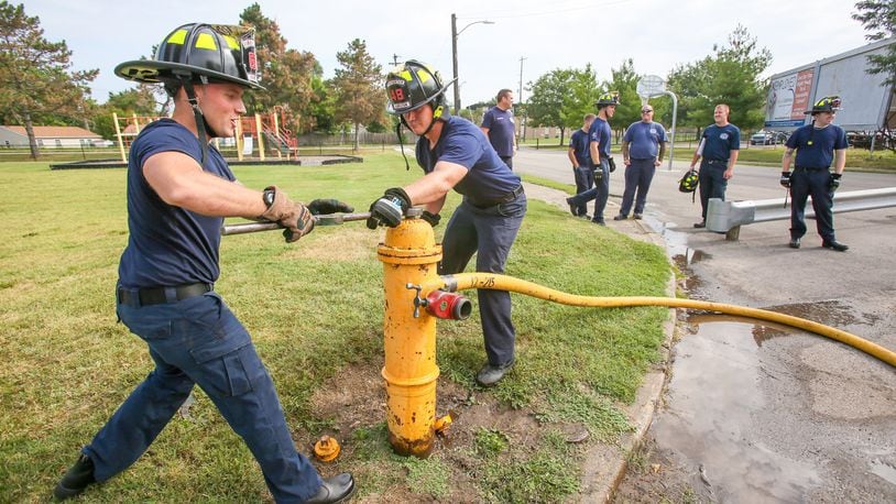 Hamilton firefighters Jon Godby and Mike Lehman, along with three other new hires, work on a hydrant outside of the Pershing Ave. station, Monday, Aug. 14, 2017. The city of Hamilton has started public discussions about its general fund finance budget, which must be approved by the end of the year. 63 cents of every dollar in Hamilton’s proposed general fund for 2018 are to go toward public safety, with 26 cents more going to other major departments. GREG LYNCH/ STAFF
