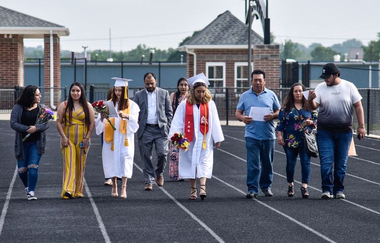 Fairfield seniors walk on the football field to get diplomas