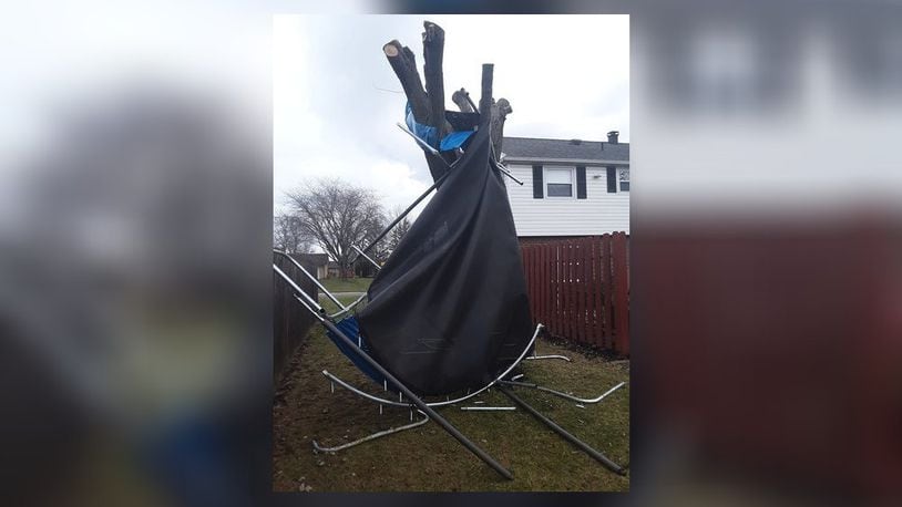 High winds picked up this trampoline and wrapped it around a tree at a home in Huber Heights Monday morning. Contributed photo