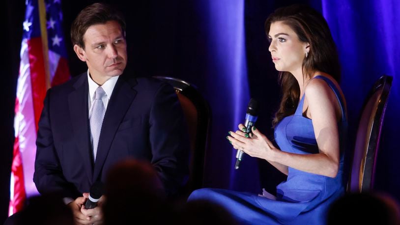 Florida Gov. Ron DeSantis, left, with his wife, Casey, a Troy native, talk to the crowd at the Butler County GOP Lincoln Day dinner Thursday, April 13, 2023 at The Savannah Center in West Chester Township. NICK GRAHAM/STAFF