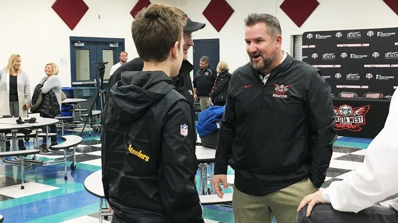 New Lakota West High School football coach Tom Bolden was the center of attention Tuesday in the school cafeteria during a meet-the-coach gathering. RICK CASSANO/STAFF