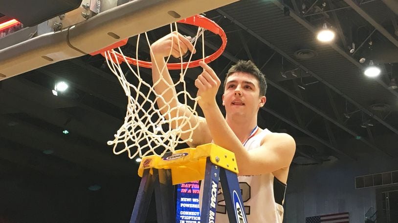 Lakota East’s Bash Wieland cuts down the net after the Thunderhawks defeated Fairmont 50-36 to win a Division I district basketball championship March 9, 2019, at the University of Dayton Arena. RICK CASSANO/STAFF