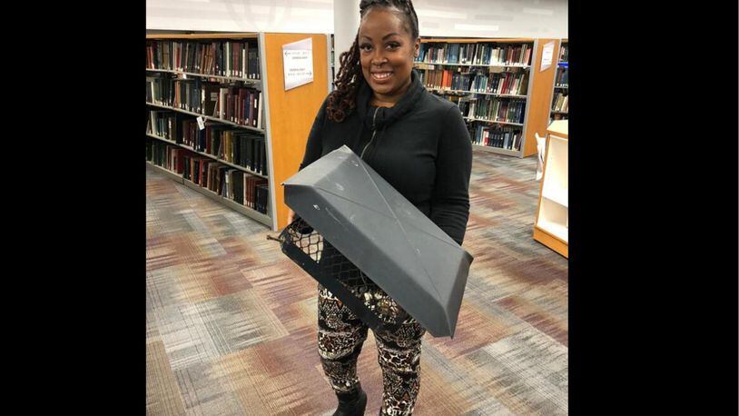 Dayton area resident shared stories of survival as part of the Dayton Strong Storytelling Sessions recorded at the Dayton Metro Library. Billi Ewing is pictured. Ewing and her family survived the Memorial Day tornadoes in Trotwood and were helped by others. She holds a piece of her home.