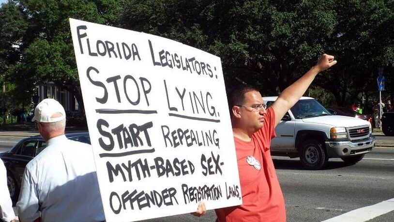Derek Logue, a Cincinnati registered sex offender who challenges registration laws, holds a sign at a rally event in Tallahassee, Fla. in April, 2015. (Credit: OnceFallen.com)