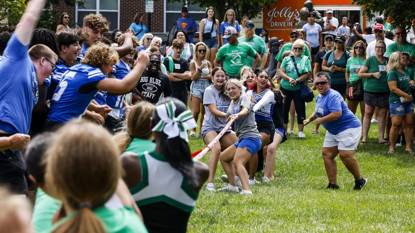 Hamilton Big Blue and Badin Rams football players, cheerleaders and fans gathered for a combined pep rally with tug of war, chicken wing eating contest, footlong coney making contest and more Saturday, Aug. 12, 2023 at Marcum Park in Hamilton. Hamilton plays Badin next Friday. NICK GRAHAM/STAFF