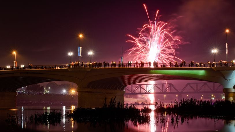 Fireworks are set off in Hamilton as folks stand on the High Main Bridge to see them. NICK GRAHAM/FILE PHOTO