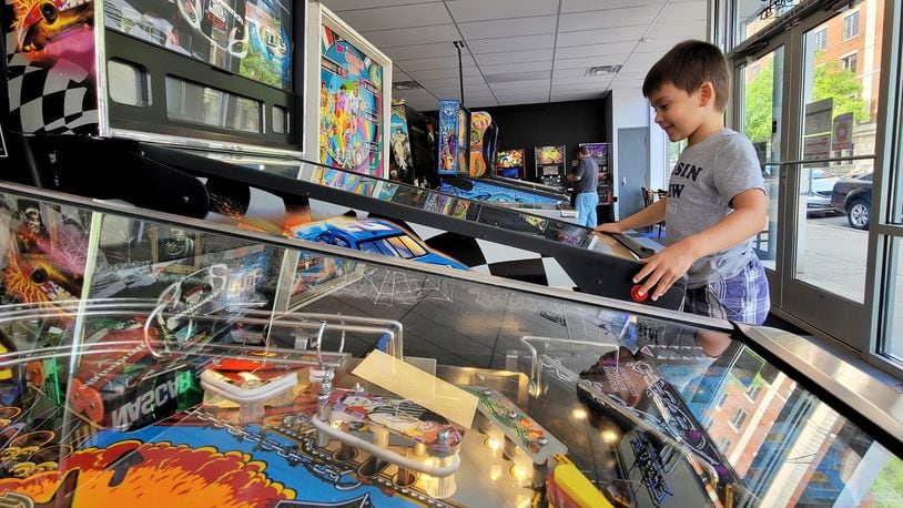 Judah Schram, 6, plays a game at Pinball Garage Thursday, May 20, 2021 in Hamilton. An expansion is planned for Pinball Garage that will add more pinball games and food options. NICK GRAHAM / STAFF