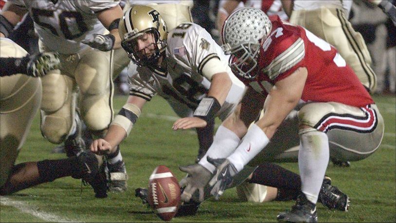 COLUMBUS, OH - NOVEMBER 15: Mike Kudla #57 of the Ohio State Buckeyes recovers a fumble by quarterback Kyle Orton #18 of the Purdue Boilermakers for a touchdown during the fourth quarter on November 15, 2003 at Ohio Stadium in Columbus, Ohio. Ohio State defeatede Purdue 16-13. (Photo by David Maxwell/Getty Images)