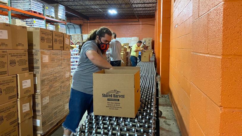 Shared Harvest employee William Sizemore, of Hamilton, packs boxes of food at the food bank on Sept. 1, 2021, in Fairfield, Ohio. MICHAEL D. PITMAN/STAFF