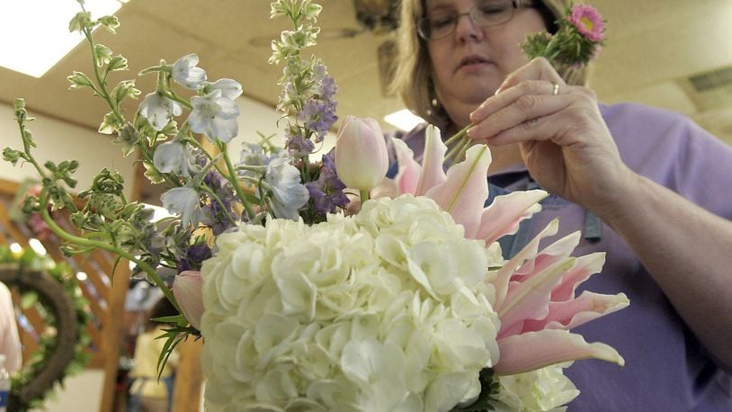 In this 2010 file photo, Tracy Armbruster, the lead designer at Armbruster Florist Inc. in Middletown, puts together a Mothers Day arrangement. Armbruster died May 1 at age 49. STAFF FILE PHOTO