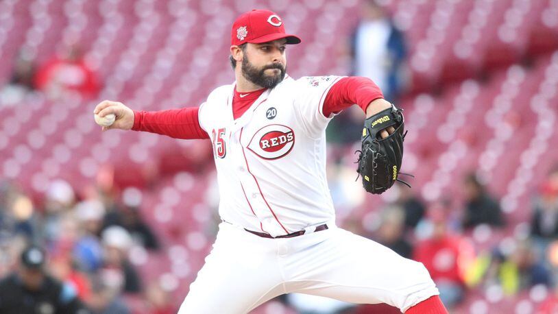 Reds starter Tanner Roark pitches against the Brewers on Monday, April 1, 2019, at Great American Ball Park in Cincinnati. David Jablonski/Staff