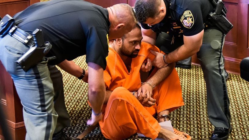 Gurpreet Singh, the West Chester man facing 4 counts of capital murder for the shooting death of 4 family members, was arraigned in Butler County Common Pleas Court Monday, August 5 in Hamilton. Singh fell to the ground while standing at the podium during the arraignment and was help up by Butler County Sheriff’s deputies. NICK GRAHAM/STAFF