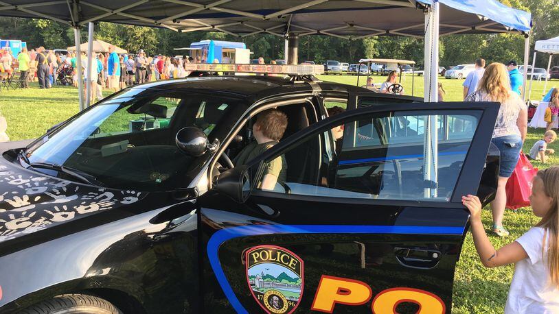 Franklin children got a chance to sit in the drivers seat of a police cruiser during the city’s first National Night Out at Community Park. ED RICHTER/STAFF