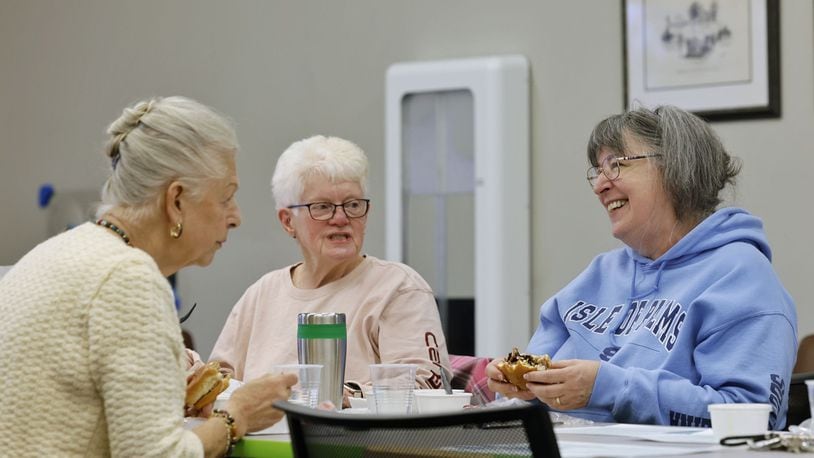 Erla Aulfinger, left, and Patty Powell, middle, and Kathy Dixon laugh as they gather for lunch at the MidPointe Library in Trenton Wednesday, Nov. 22, 2023. Adults 60 and older meet every Wednesday for a provided meal. Registration is required. NICK GRAHAM/STAFF