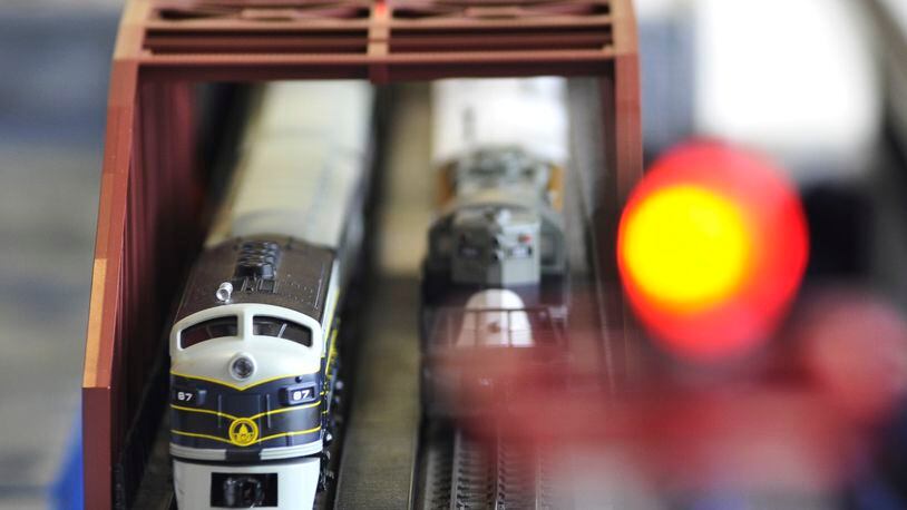 Hamilton’s holiday train exhibit allows viewers to press buttons to make them run.