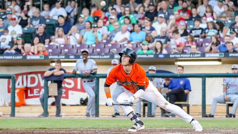 Dayton Dragons centerfielder Michael Siani watches his bunt attempt fly into the air during their game against the Wisconsin Timber Rattlers on Friday night at Fifth Third Field. The Timber Rattlers won 4-2. CONTRIBUTED PHOTO BY MICHAEL COOPER