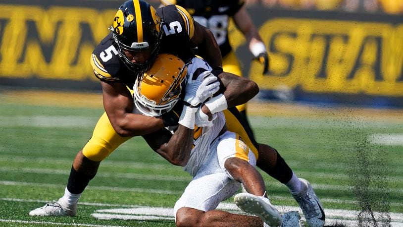 Kent State wide receiver Dante Cephas (14) is tackled by Iowa linebacker Jestin Jacobs (5) after catching a pass during the first half of an NCAA college football game, Saturday, Sept. 18, 2021, in Iowa City, Iowa. (AP Photo/Charlie Neibergall)