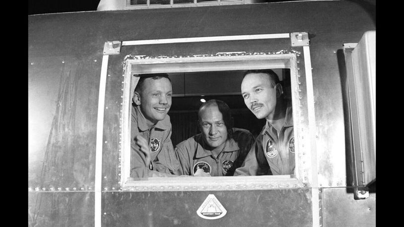 In this July 27, 1969 file photo, Apollo 11 crew members, from left, Neil Armstrong, Buzz Aldrin and Michael Collins sit inside a quarantine van in Houston.