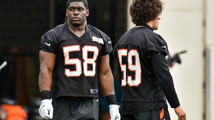Bengals’ linebackers Carl Lawson (left) and Nick Vigil. Lawson is back from a season-ending ACL injury last year. NICK GRAHAM/STAFF