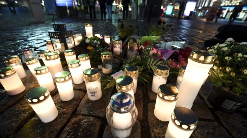 Flowers and candles have been left at the Turku Market Square, where several people were stabbed on Friday.