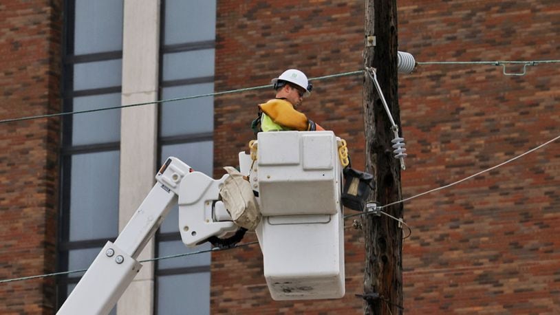 Hamilton city crews work to restore power on Dayton Street after storms with heavy rain and strong winds caused power outages and down trees and limbs around Butler County Monday evening, June 13, 2022. NICK GRAHAM/STAFF