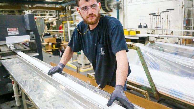 Jake Steffen of Middletown works at an extruder machine at Deceuninck North America in Monroe, Wednesday, April 12, 2017. Deceuninck North America is a fully integrated design, compounding, tooling, and PVC extrusion company that produces energy-efficient vinyl window and door systems. GREG LYNCH / STAFF