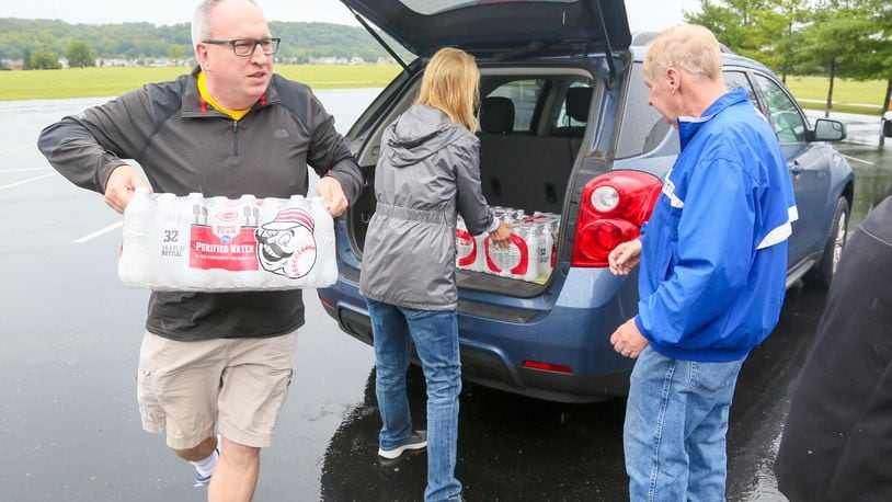 Jim Robishch, left, delivers water to Fairfield West Baptist Church, which partnered with Matthew 25: Ministries as a designated drop-off site to collect relief items for Houston and surrounding areas affected by flooding from Hurricane Harvey. Fenwick High School is collecting donations through Sept. 15 for Hurricane Harvey victims. GREG LYNCH/STAFF