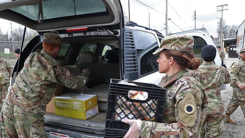 Ohio Gov. Mike DeWine on July 2, 2021, activated 185 additional Ohio National Guard members to support the Southwest border mission late this year at the request of the U.S. Department of Homeland Security and the National Guard Bureau. Pictured, Ohio National Guard members based in Springfield helped distributed food Jan. 13, 2021, at the Second Harvest Food Bank as a line of cars, waiting for food, wrapped around the food bank in Springfield.  BILL LACKEY/STAFF
