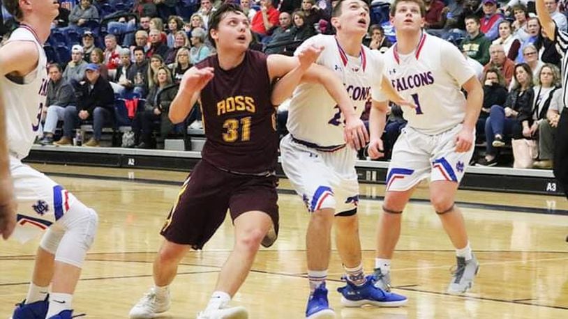 Sean Lange of Ross battles Clinton-Massie’s Nate Baker (21) for rebounding position during Friday night’s Division II sectional basketball game at Fairmont’s Trent Arena in Kettering. Clinton-Massie won 61-54 in overtime. CONTRIBUTED PHOTO BY TERRI ADAMS