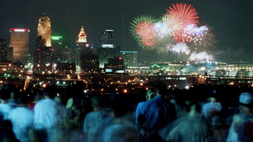 Crowds watch a past Riverfest fireworks from a park overlooking downtown Cincinnati. ASSOCIATED PRESS