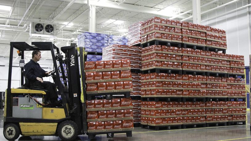 A warehouse operations worker at Heidelberg Distributing moves pallets of beer in July 2013 inside the company’s then-new distribution center in the former Cooper Tire building in Moraine. FILE PHOTO BY CHRIS STEWART / STAFF