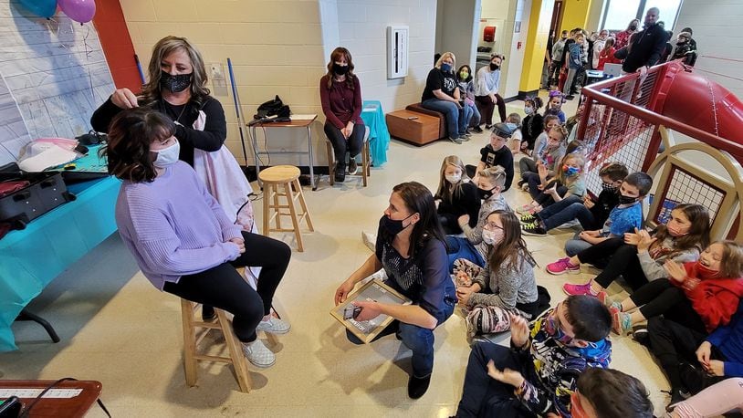Jody Cole, from American Hair Company, cuts the hair of fourth-grader Sophia Muniz. Several Madison Elementary School students and teachers donated their hair Monday, March 1, 2021 to help others who made need it. NICK GRAHAM / STAFF