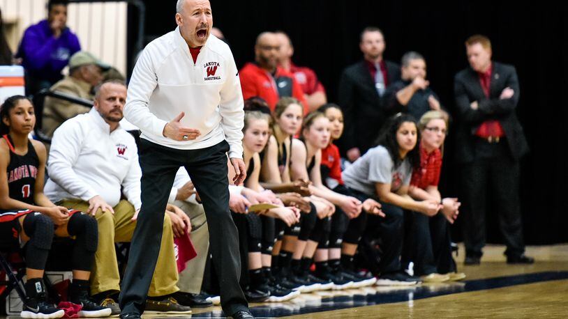 Lakota West coach Andy Fishman in action Wednesday night during the Firebirds’ 60-31 win over Walnut Hills in a Division I regional semifinal at Fairmont’s Trent Arena. NICK GRAHAM/STAFF