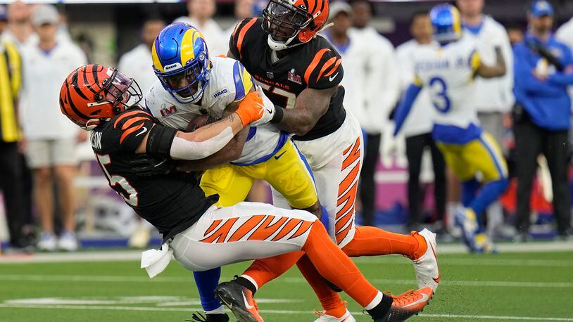 Los Angeles Rams running back Cam Akers, middle, is tackled by Cincinnati Bengals inside linebacker Logan Wilson, left, and outside linebacker Germaine Pratt during the first half of the NFL Super Bowl 56 football game Sunday, Feb. 13, 2022, in Inglewood, Calif. (AP Photo/Chris O'Meara)