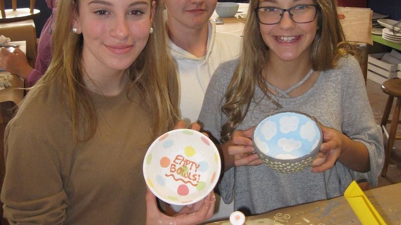 Students from Talawanda Middle School’s Junior Honor Society painted bowls at You’re Fired! for this year’s Oxford Empty Bowls benefit soup luncheon. CONTRIBUTED