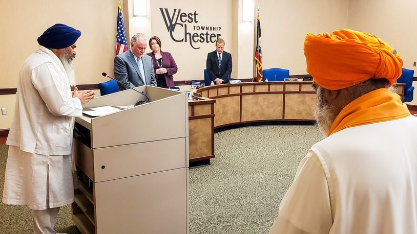 Amrik Singh, left, head priest of Guru Nanak Society of Greater Cincinnati, offered prayers for the Sikh community and those involved in the quadruple homicide last week during the West Chester Township trustees meeting Tuesday, May 7, 2019. NICK GRAHAM/STAFF