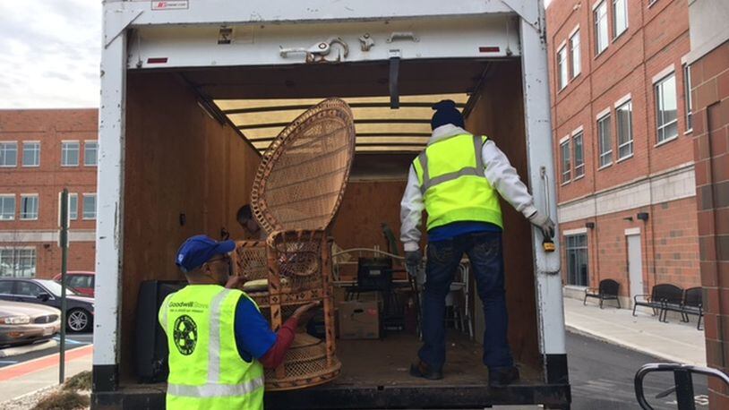 David Battles, left, and Dennis Glover, both Goodwill workers, help unload a chair delivered to the donation center at the 660 S. Main St. Goodwill Easter Seals Miami Valley headquarters Dec. 7. THOMAS GNAU/STAFF