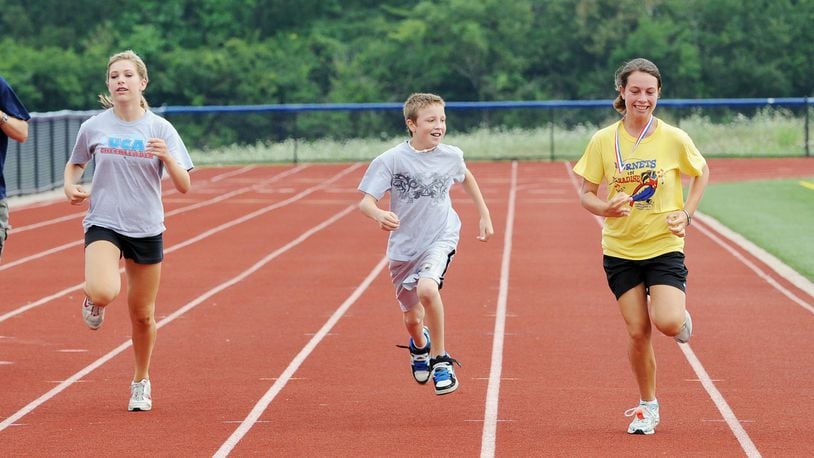 Some area high school stadium running tracks have re-opened after being shuttered for months due to coronavirus prevention measures. The tracks are popular exercise spots for area walkers and joggers like this area family from years past. (File Photo/Journal-News)