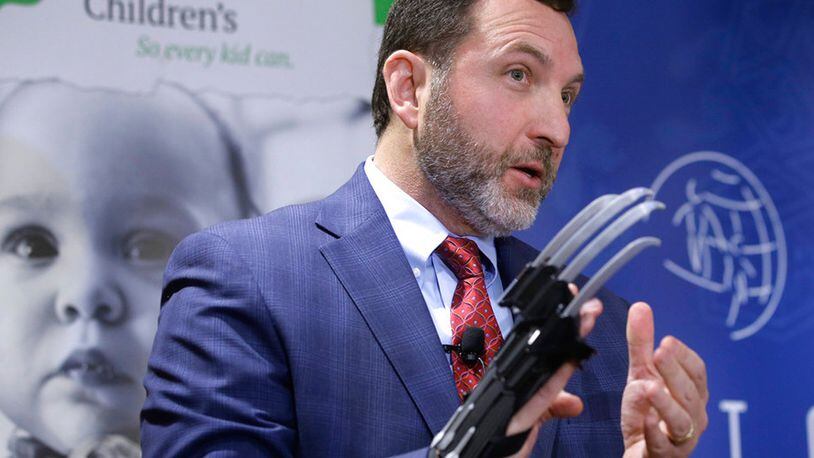 James Swartz, director of the Massachusetts-based consumer safety group World Against Toys Causing Harm, or W.A.T.C.H., displays a Black Panther "slash claw" as he introduces toys topping the group's annual list of worst toys for the holiday season, during a news conference, Tuesday, Nov. 13, 2018, at a hospital, in Boston. The group says the Black Panther "slash claw" has the potential for eye and facial injuries.
