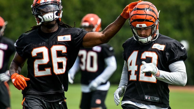 Bengals’ safety Josh Shaw (26) pats fellow safety Clayton Fejedelem on the helmet during organized team activities Tuesday, May 22 at the practice facility near Paul Brown Stadium in Cincinnati. NICK GRAHAM/STAFF