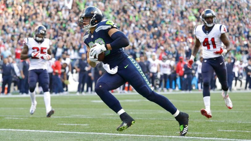 Seattle Seahawks tight end Jimmy Graham (88) scores a touchdown against the Houston Texans in the second half of an NFL football game, Sunday, Oct. 29, 2017, in Seattle. It was Graham's second touchdown in the second half of the game and the Seahawks won 41-38. (AP Photo/Elaine Thompson)
