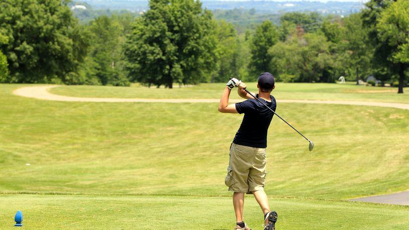 A golfer tees of at Twin Run golf course in Hamilton. Rates are dropping at Twin Run golf course as an incentive for players to check out the course. STAFF FILE PHOTO