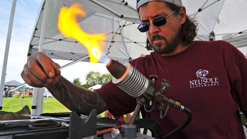 NEW ARTLINE FOR 2019: Justin Davis with Neusole Glassworks heats glass during a live demo at the 2018 Middletown Arts Festival. The event returns for its sixth year Sept. 14 on Central Avenue. NICK GRAHAM/STAFF ORIGINAL ARTLINE: Justin Davis with Neusole Glassworks heats glass during a live demo at the Middletown Arts Festival Sunday, Sept. 16 in Middletown. Painters, glass artists, woodworkers, musicians, food vendors and more gathered in downtown Middletown for the event. NICK GRAHAM/STAFF