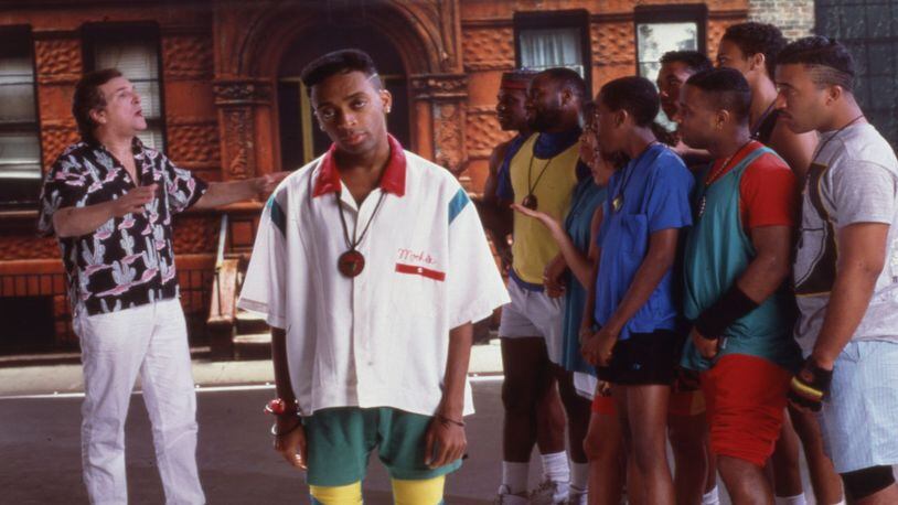 Portrait of American film director and actor Spike Lee (center) on the set of his film 'Do the Right Thing,' New York, 1989. Among the cast behind him is actor Danny Aiello (left).