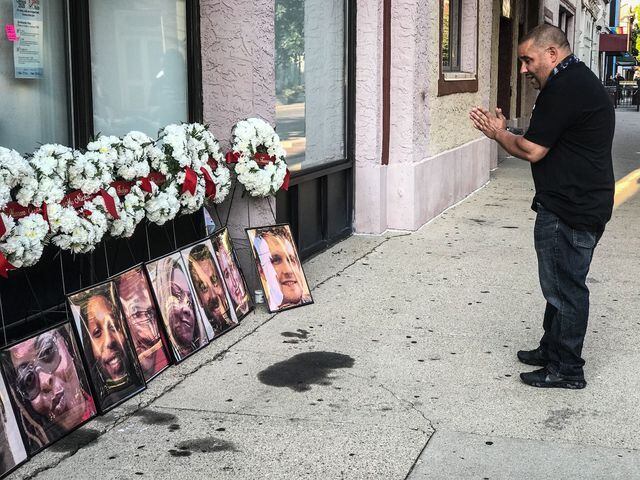 Ned Pepper’s bouncer Jeremy Ganger talks to the memorial for the victims on 5Th St. in the Oregon.