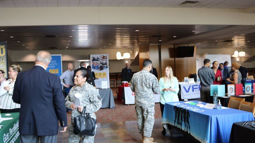 Participants and company officials talk during RecruitMilitary’s All-Veteran Career Fair in 2016 in southwest Ohio. CONTRIBUTED
