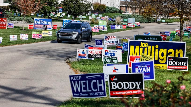 Political signs line the entrance for early voting Monday, Nov. 1, 2021 at the Butler County Board of Elections in Hamilton. NICK GRAHAM/STAFF