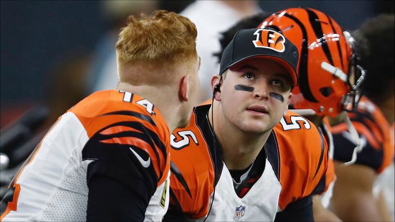 HOUSTON, TX - DECEMBER 24: AJ McCarron #5 of the Cincinnati Bengals talks with Andy Dalton #14 of the Cincinnati Bengals on the bench during the game against the Houston Texans at NRG Stadium on December 24, 2016 in Houston, Texas. (Photo by Tim Warner/Getty Images)