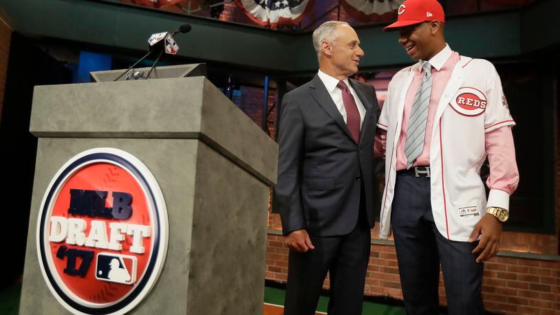 Hunter Greene, right, a pitcher and shortstop from Notre Dame High School in Sherman Oaks, Calif., talks to commissioner Rob Manfred after being selected No. 2 by the Cincinnati Reds in the first round of the Major League Baseball draft, Monday, June 12, 2017, in Secaucus, N.J.(AP Photo/Julio Cortez)