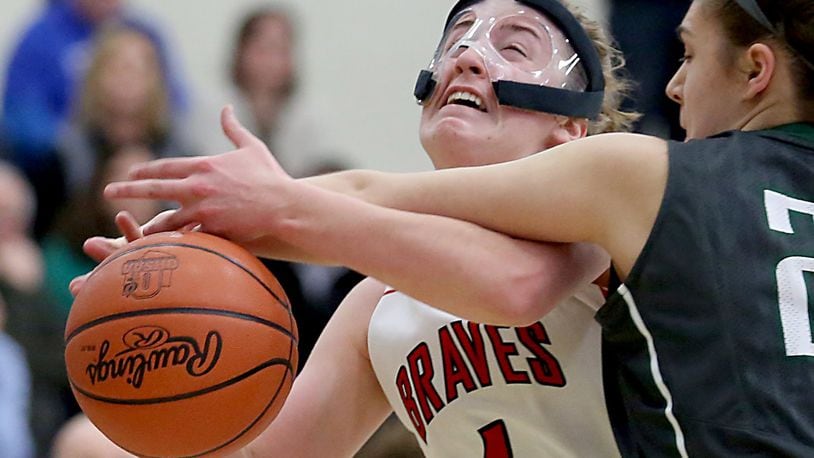 Talawanda guard Emma Wright is fouled by Ursuline forward Emma Cain during Wednesday night’s Division I sectional game at Lakota East. CONTRIBUTED PHOTO BY E.L. HUBBARD